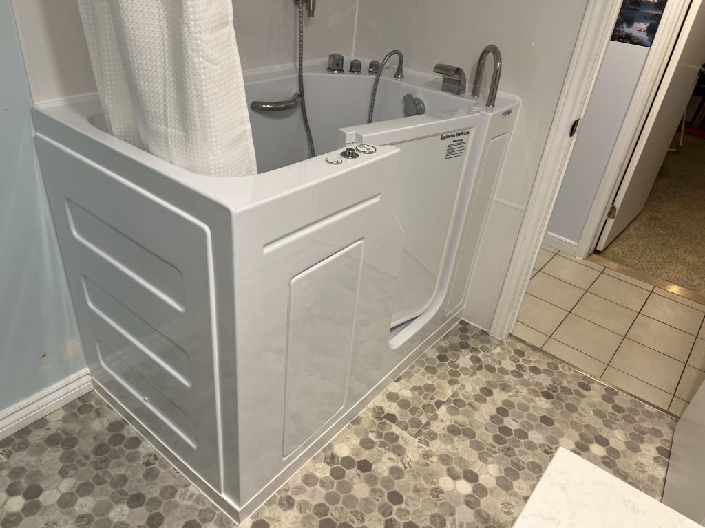 Walk-in bathtub installed with hexagonal tile flooring