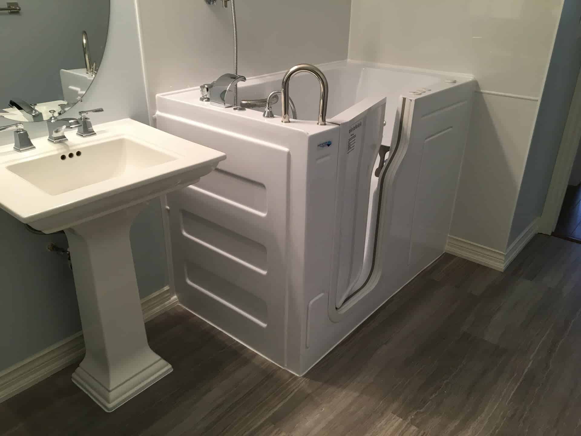 Accessible walk-in bathtub with grab bars installed in Ontario